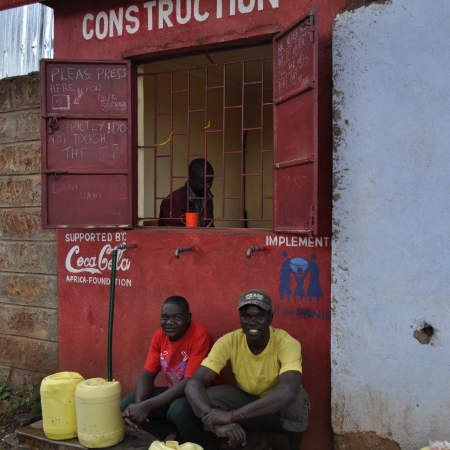 Men at a water storefront, Kibera slum