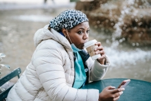 A weary health care worker sips coffee on a break (credit: Laura James from Pexels)